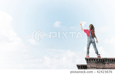 Concept of careless happy childhood with girl dreaming to become Concept of careless happy childhood with girl dreaming to become 42423676