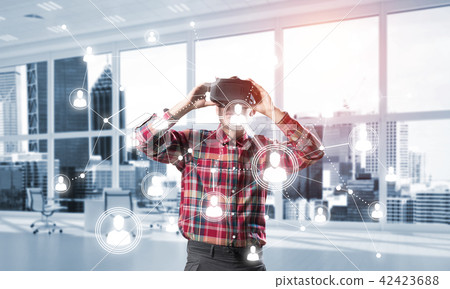Guy wearing checked shirt and virtual mask reaching hand to touch screen Guy wearing checked shirt and virtual mask reaching hand to touch screen 42423688