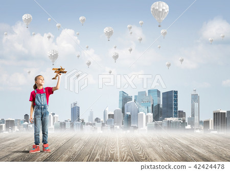 Concept of careless happy childhood with girl dreaming about something 42424478