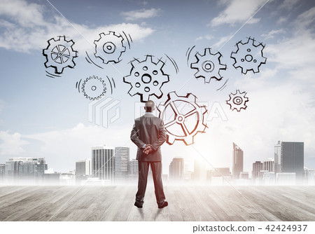 Cogwheel engine drawn on screen as symbol for teamwork and cooperation Cogwheel engine drawn on screen as symbol for teamwork and cooperation 42424937