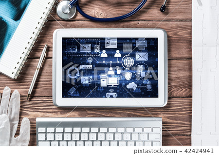 Concept of modern medicine with tablet on wooden table from top view Concept of modern medicine with tablet on wooden table from top view 42424941