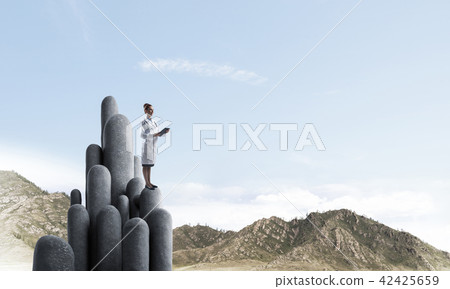 Medicine specialist or practitioner outdoors standing on top 42425659