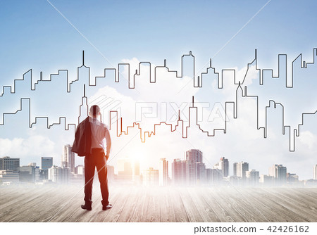 Motivation and inspiration concept with modern cityscape and businessman observing it Motivation and inspiration concept with modern cityscape and businessman observing it 42426162