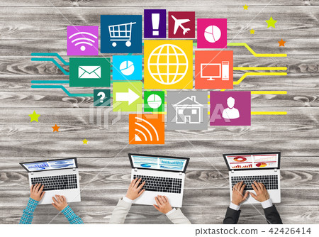 Top view of businesspeople sitting at table and using gadgets Top view of businesspeople sitting at table and using gadgets 42426414