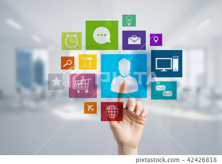 Modern office interior and close of businesswoman hand choosing icon on multimedia interface Modern office interior and close of businesswoman hand choosing icon on multimedia interface 42426818