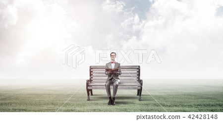 Young businessman or student studying the science in summer park Young businessman or student studying the science in summer park 42428148
