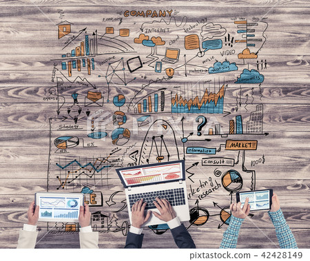 Top view of businesspeople sitting at table and using gadgets Top view of businesspeople sitting at table and using gadgets 42428149