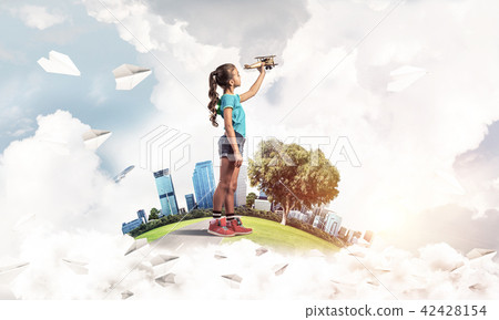 Concept of careless happy childhood with girl dreaming to become pilot Concept of careless happy childhood with girl dreaming to become pilot 42428154