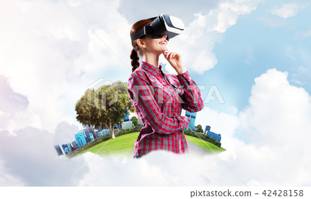 Girl in checked shirt wearing VR glasses experiencing another reality 42428158
