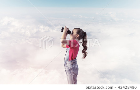 Concept of careless happy childhood with girl looking in binoculars 42428480