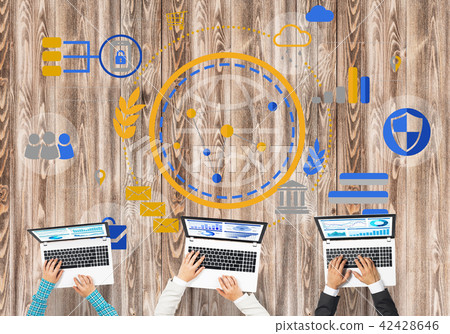 Top view of businesspeople sitting at table and using gadgets Top view of businesspeople sitting at table and using gadgets 42428646