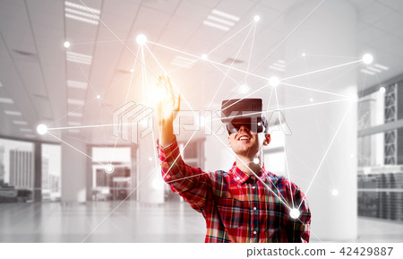 Guy wearing checked shirt and virtual mask reaching hand to touch screen Guy wearing checked shirt and virtual mask reaching hand to touch screen 42429887