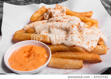 French fries on top with chesse served with sauce French fries on top with chesse served with sauce 42435582