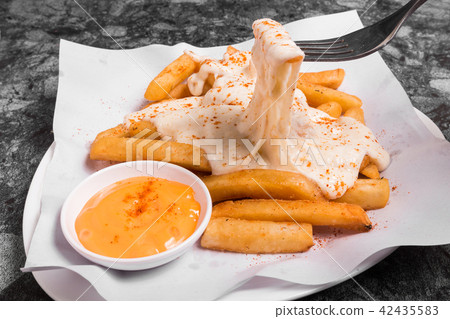 French fries on top with chesse served with sauce French fries on top with chesse served with sauce 42435583