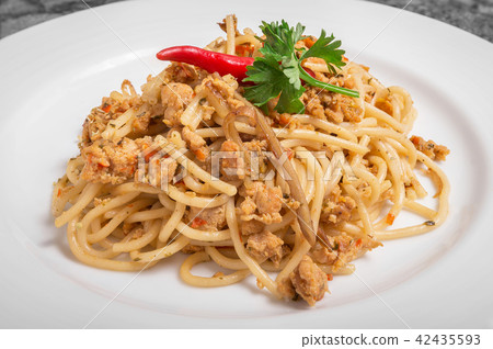 Spicy pork spaghetti on a white plate Spicy pork spaghetti on a white plate 42435593