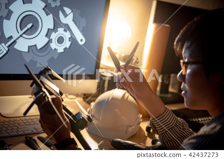 Asian technical engineer repairing drone 42437273