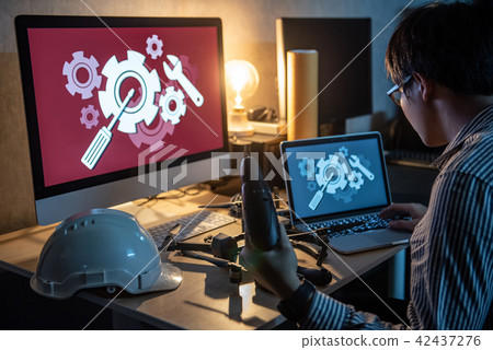 Technician using screwdriver for repairing drone 42437276