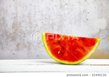 Piece of watermelon on a wooden table Piece of watermelon on a wooden table 42440130