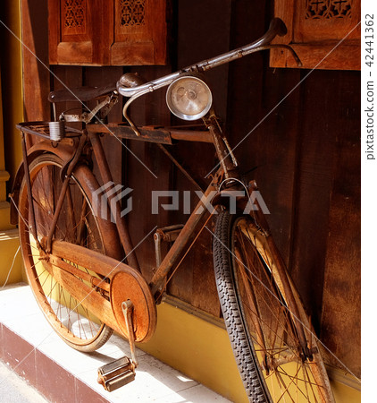 Close up old rusty bicycle with wood wall, vintage Close up old rusty bicycle with wood wall, vintage 42441362
