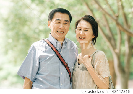 Japanese middle-aged couple traveling in summer resort Japanese middle-aged couple traveling in summer resort 42442846