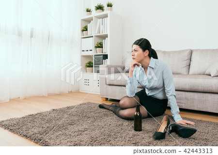 businesswoman is drinking away her sorrow businesswoman is drinking away her sorrow 42443313