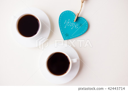 two cups of coffee on the table that says home two cups of coffee on the table that says home 42443714