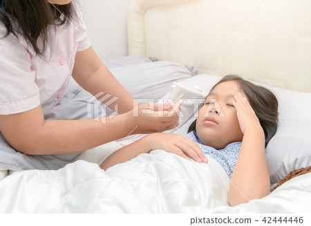 Mother measuring temperature of her ill kid. 42444446