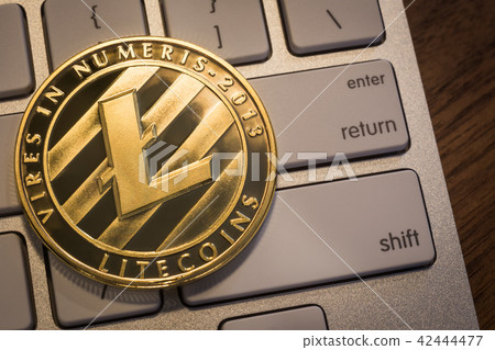 Cryptocurrency gold Litecoins on keyboard. Cryptocurrency gold Litecoins on keyboard. 42444477