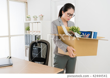 woman packing and leaving her office 42444541