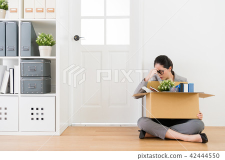 woman sitting on the wooden floor in trouble woman sitting on the wooden floor in trouble 42444550