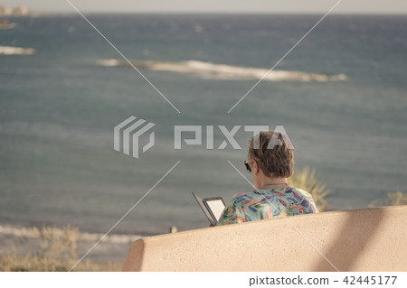 Older woman is sitting on bench Older woman is sitting on bench 42445177
