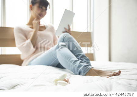 A Japanese woman watching a tablet A Japanese woman watching a tablet 42445797