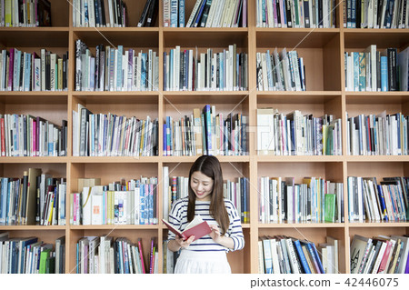 woman reading a book in library