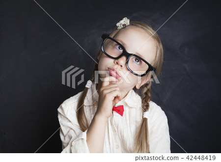 Schoolgirl Child Thinking and Looking Up Schoolgirl Child Thinking and Looking Up 42448419