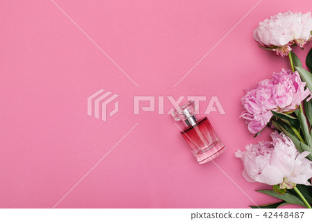 bottle of perfume and peony flowers 42448487