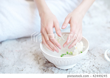 Woman In Beauty Salon Holding Hands In Aroma Bath Before Spa Procedure Woman In Beauty Salon Holding Hands In Aroma Bath Before Spa Procedure 42449245