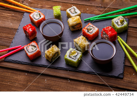 Sushi Set rolls with soy sauce served on gray stone slate 42449734