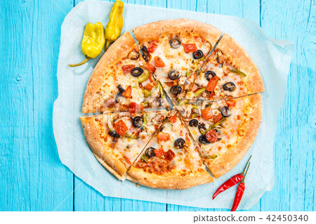 Vegetarian pizza with vegetables on blue table. 42450340