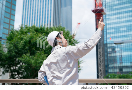 Businessman / finger pointing / skyscraper 42450892