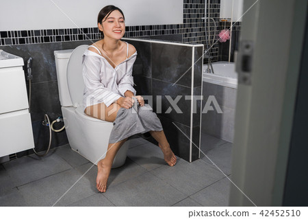 happy woman sitting on a toilet 42452510