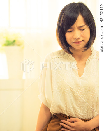 Young woman with stomachache Young woman with stomachache 42452539
