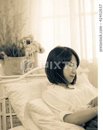 Tormented young gril in her bedroom 42452637