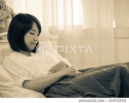 Tormented young gril in her bedroom 42452638