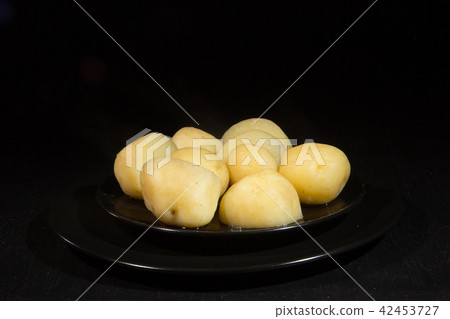 Welded potatoes on a black plate 42453727