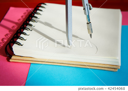 The compasses draw a circle in a notebook  The compasses draw a circle in a notebook  42454068