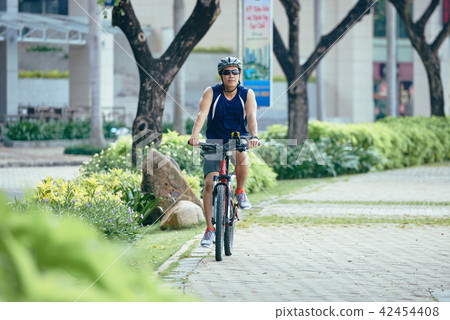 Man riding bicycle 42454408