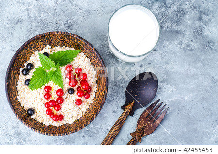 Oat flakes with berries, milk in glass 42455453