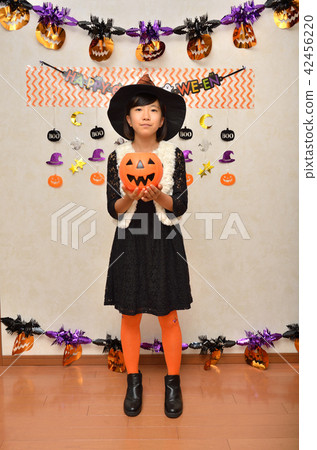 A girl who enjoys a Halloween party A girl who enjoys a Halloween party 42456220