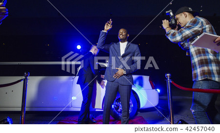 Famous ethnic actor posing on red carpet Famous ethnic actor posing on red carpet 42457040