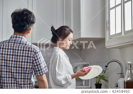 Washing dishes in a single-life kitchen 42459495
